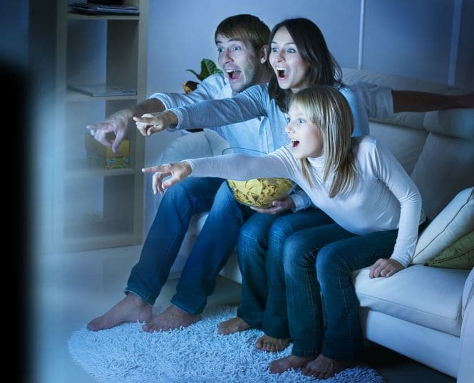 A family watching TV together.