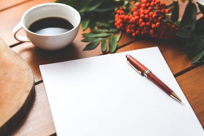 A cup of coffee along with a paper and pen to write a letter to your spouse.