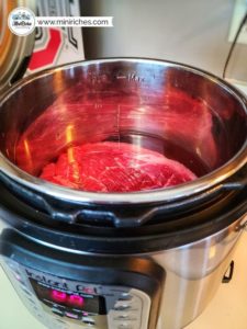 Preparing to cook a roast in an Instant Pot for mouthwatering pot roast pie.