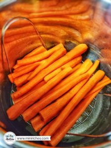 Cooking carrots in Instant Pot for mouthwatering pot roast pie.